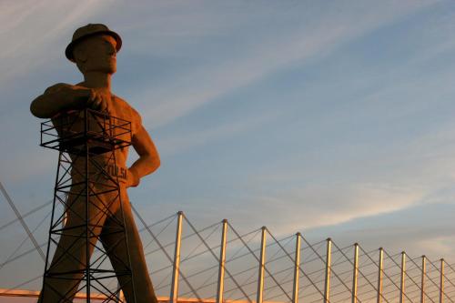 a statue of a man standing in front of a fence at SpringHill Suites by Marriott Tulsa in Union