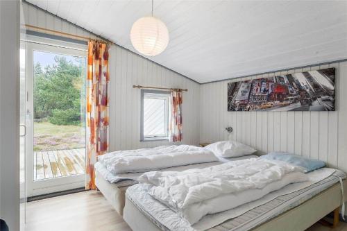 a bedroom with two beds and a window at 0240-Romo-Peder-Jespersensvej-9 in Høm