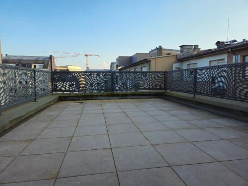 a balcony with a fence and a sidewalk at Roomies Luxembourg Centre Gare in Luxembourg