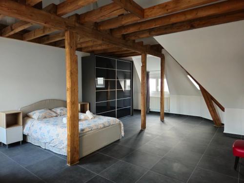 a bedroom with a bed and wooden beams at Roomies Luxembourg Centre Gare in Luxembourg