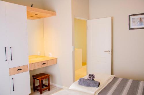 a bedroom with a bed and a mirror at Rustic Hills No 3 Self Catering in Swakopmund