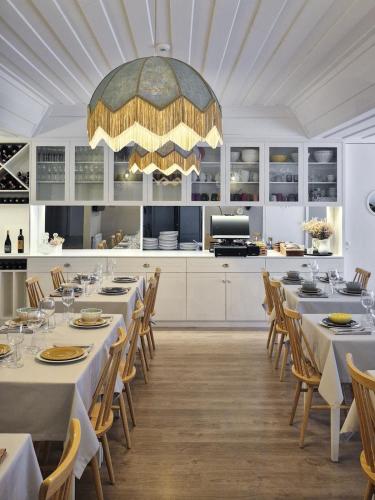 a dining room with tables and chairs and a large chandelier at Retiro do Gerês in Geres