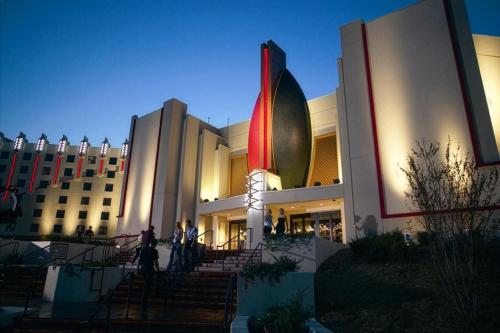 a large building with a flag in front of it at SpringHill Suites by Marriott Tulsa in Tulsa