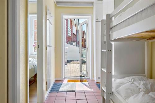 a bedroom with a bunk bed and a balcony at 0432-Romo-Vestergade-225-App-7 in Høm