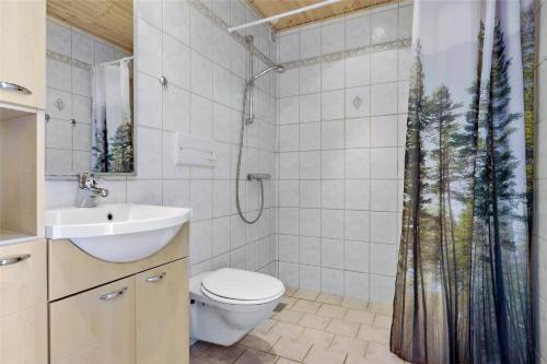 a bathroom with a shower with a toilet and a sink at 0432-Romo-Vestergade-225-App-7 in Høm