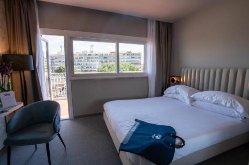 A bed or beds in a room at BV Hotel Oly
