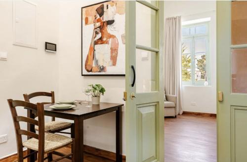 a dining room with a table and a painting on the wall at Limisso Luxury Residence In city Center in Limassol