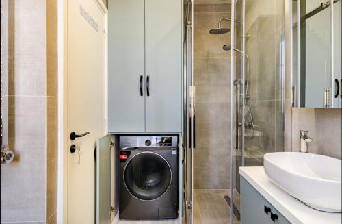 a bathroom with a washing machine and a sink at Limisso Luxury Residence In city Center in Limassol