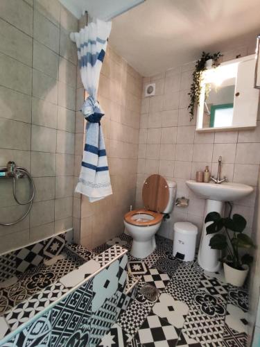 a bathroom with a toilet and a sink at SEA VIEW in Nea Skioni