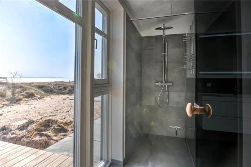 a bathroom with a shower with a view of the beach at 0226-Romo-A-M-Listsvej-4 in Høm