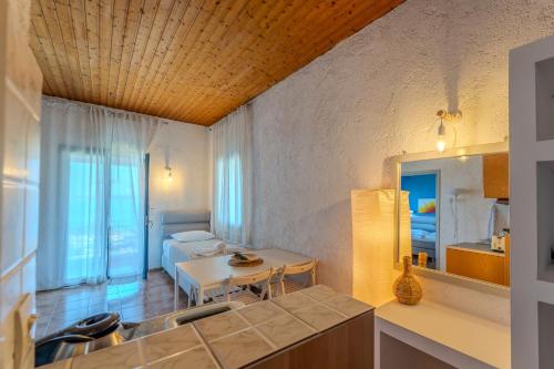 a kitchen and living room with a table and a couch at Metaxatos Apartments in Lassi