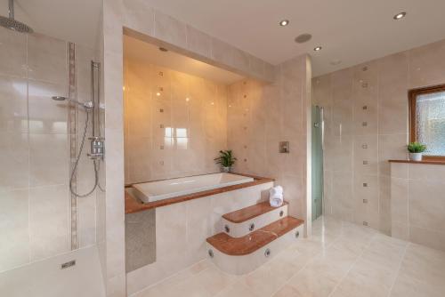 a bathroom with a bath tub and a shower at Hamble House in Southampton