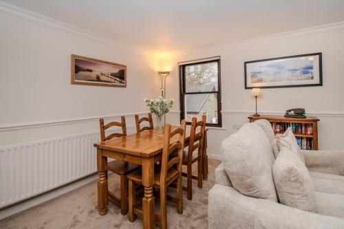 a living room with a dining room table and chairs at Aura in Keswick