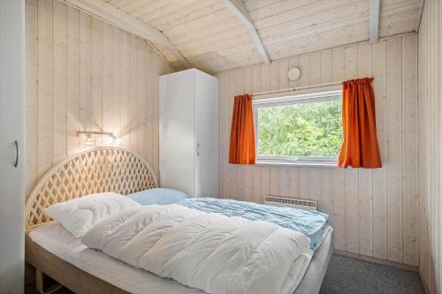 a bed in a room with a window at 0223-Romo-Sonderstrandvej-12 in Høm