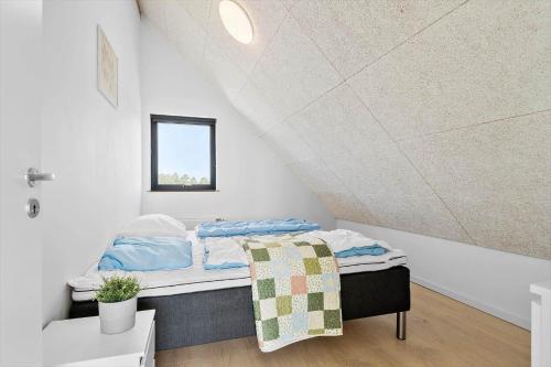 a bedroom with a bed in a attic at 0433-Romo-Vestergade-345 in Høm