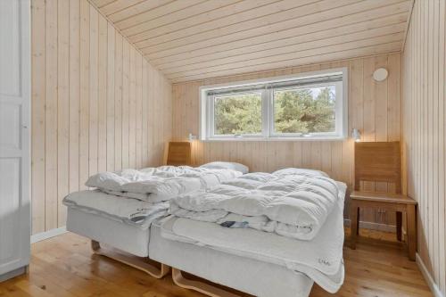 a bed in a room with a window at 0317-Romo-Sonderstrandvej-24 in Høm