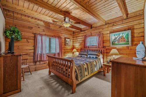 a bedroom with a bed in a log cabin at Lazy Bear Retreat - Wifi, Pet Friendly, Grill, Fire Pit, Fireplace, Deck, Golf, Hiking in Morton Grove