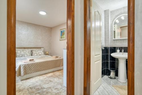a bedroom with a bed and a sink at Apartments Moskov in Kotor