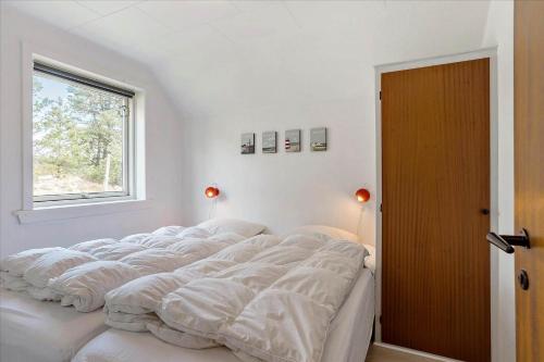 a large bed in a room with a window at 0309-Romo-Stagebjergvej-13 in Høm