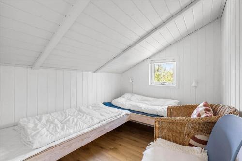 a room with two beds and a chair in it at 0252-Romo-Kromosevej-6 in Høm