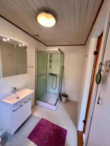 a bathroom with a glass shower and a sink at 0210-Romo-Vestergardsvej-10 in Høm