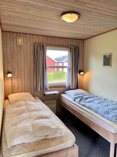 a bedroom with two beds and a window at 0210-Romo-Vestergardsvej-10 in Høm