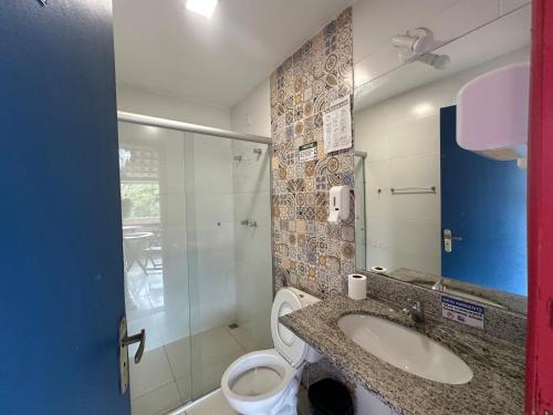 a bathroom with a toilet and a sink and a shower at Pousada Vila Catarina in Ouro Preto