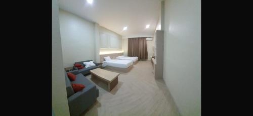 a living room with two couches and a table at Mabit Hotel Syariah in Takengon