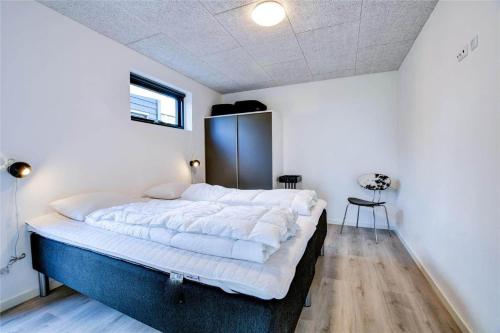 a bedroom with a large bed in a room at 0374-Romo-Vestergade-337 in Høm