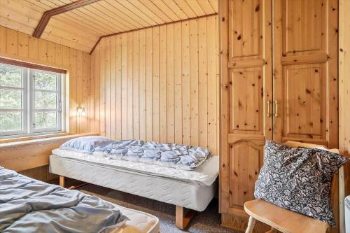 a bedroom with two beds and a window at 0225-Romo-Kromosevej-22-A in Høm