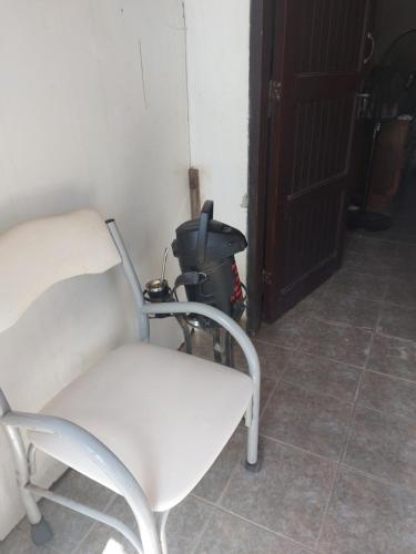 a white chair in a room with a trash can at Esperanza in Asunción