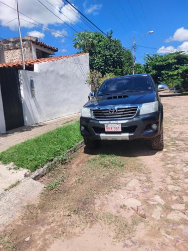 a blue truck parked on the side of a road at Esperanza in Asunción