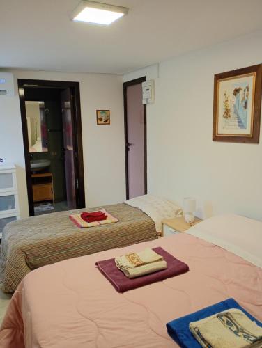two beds in a hotel room with towels on the bed at Casa Don Peppì in Monopoli
