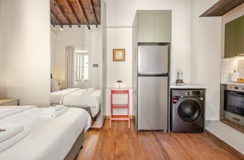 a room with two beds and a kitchen with a refrigerator at Limisso Luxury Residence In city Center in Limassol