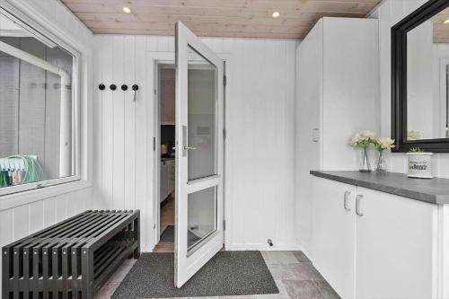 a hallway with a mirror and a bench in a room at 2801-Romo-Helmusager-4 in Høm