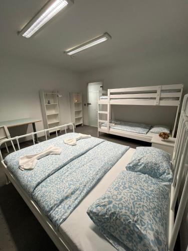 a bedroom with two beds and two bunk beds at COliving RD6 in Ljubljana
