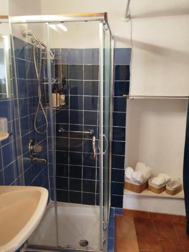 a bathroom with a shower and a sink at Αιθεροβάμων - Etherovamon in Areopoli