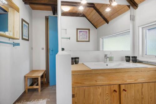 a bathroom with a sink and a mirror at 0337-Romo-Kliren-1 in Høm