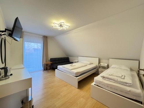 a living room with two beds and a couch at Asiatisches Ferienhaus in Merseburg
