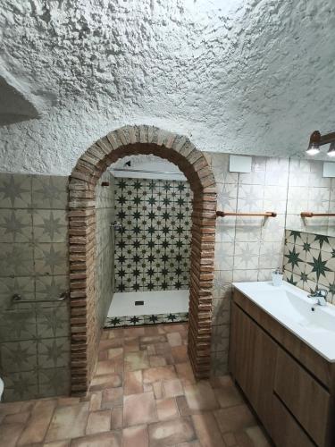 a bathroom with a shower and a sink at Cuevas Uropia in Graena