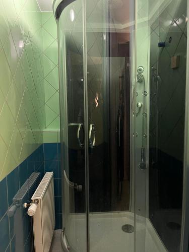 a shower with a glass door in a bathroom at COliving RD6 in Ljubljana