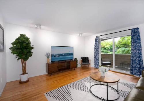 a living room with a flat screen tv on a wall at Greenlake urban lodge in Seattle