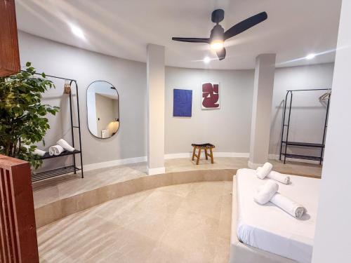a room with two beds and a ceiling fan at Studios Mugakoa By Sahats in Portugalete