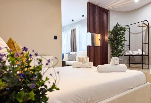 a hotel room with two beds with towels on them at Studios Mugakoa By Sahats in Portugalete