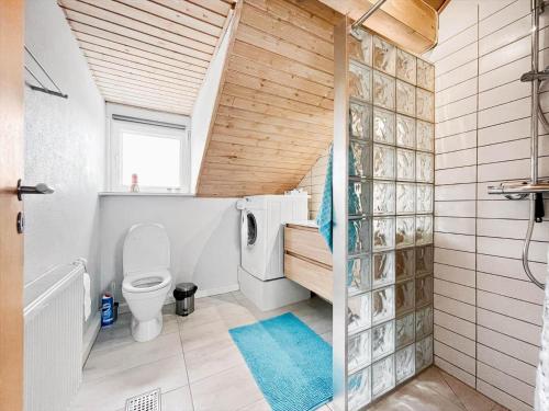 a bathroom with a toilet and a shower with a window at 0353-Romo-Vestergade-155-B-Ap-130 in Høm