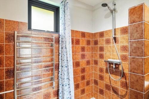 a bathroom with a shower and a window at 0187-Romo-Egedesminde-1 in Høm