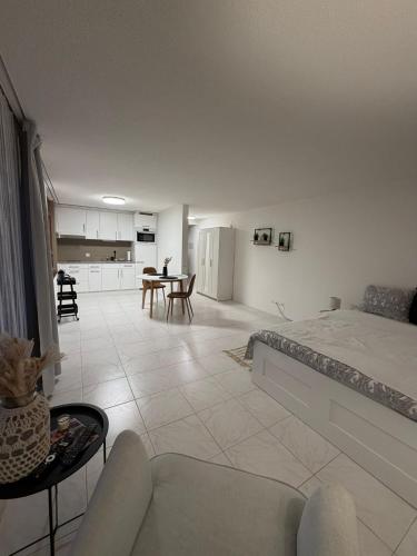 a bedroom with a bed and a living room at Studio Lakeview in Ennetbürgen