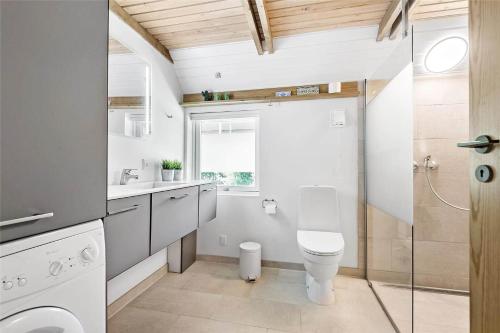 a bathroom with a toilet and a sink at 0314-Romo-Kliren-3 in Høm