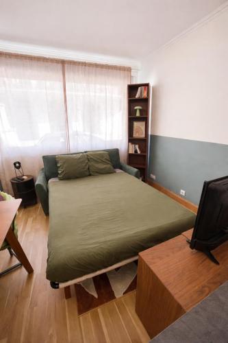a bedroom with a bed and a couch in it at Studio plein centre in Aix-les-Bains