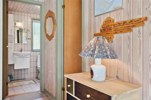 a lamp on a dresser in a bathroom at 0215-Romo-Vestergardsvej-8 in Høm